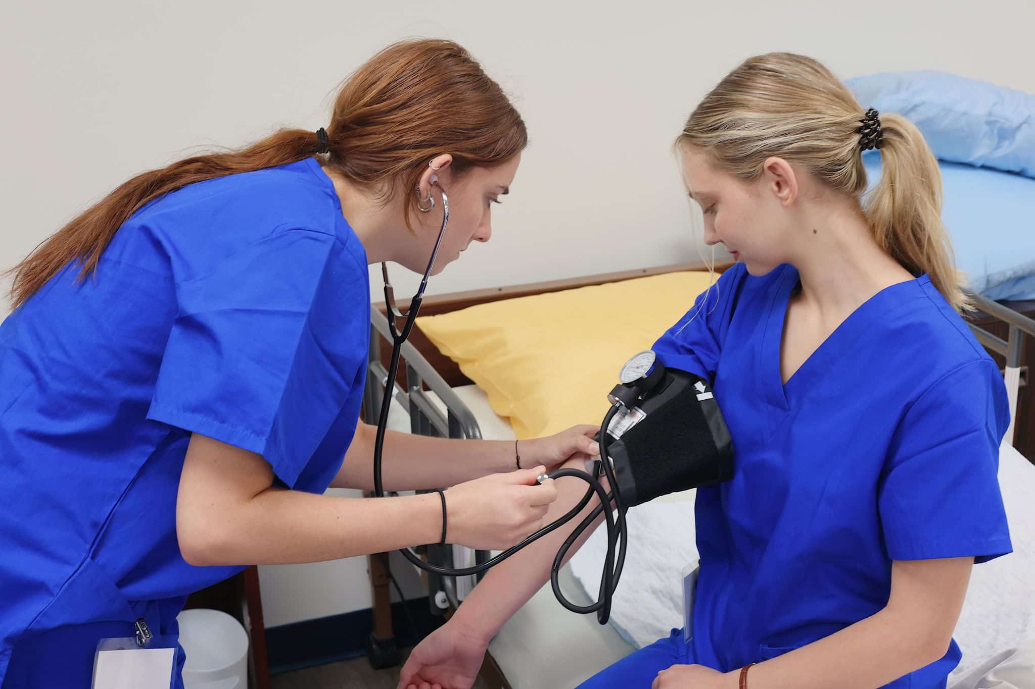 Students learning how to take blood pressure